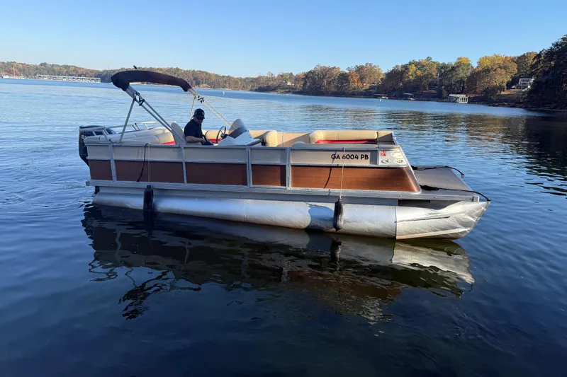 The Image of 1997 Crest CREST II DLX pontoon boat on a calm lake. - 1