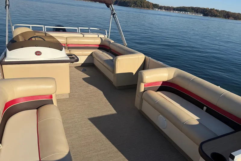 Slide: The Image of 1997 Crest CREST II DLX pontoon boat with beige seating on a calm lake. - 11