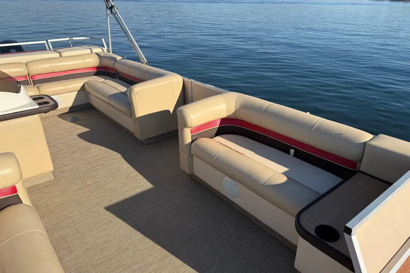 Slide: The Image of 1997 Crest CREST II DLX pontoon boat with beige seating on calm water. - 14