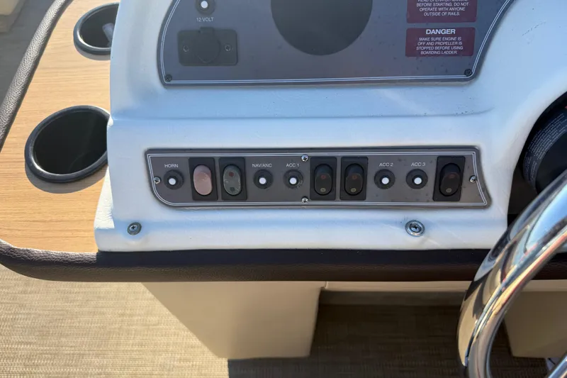 Slide: The Image of 1997 Crest CREST II DLX boat dashboard with control switches and cup holders. - 17