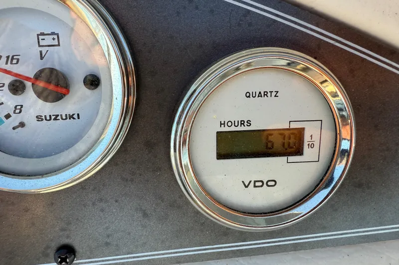 Slide: The Image of Close-up of 1997 Crest II DLX boat gauges, showing voltage and engine hours. - 19