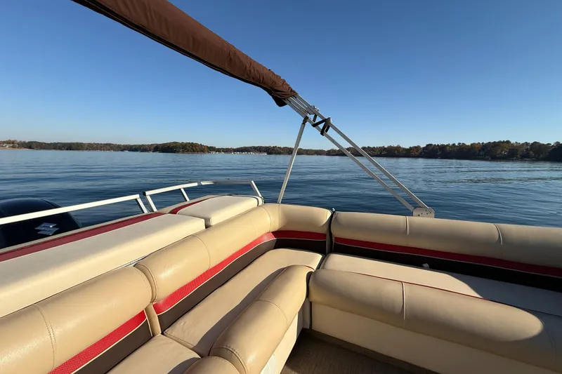 Slide: The Image of 1997 Crest CREST II DLX pontoon boat on a serene lake under clear blue skies. - 24