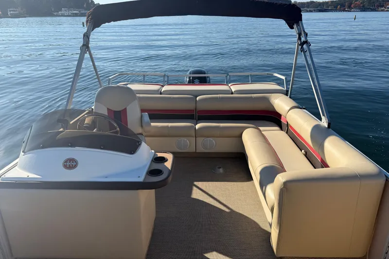Slide: The Image of 1997 Crest CREST II DLX pontoon boat with beige seating on a calm lake. - 25