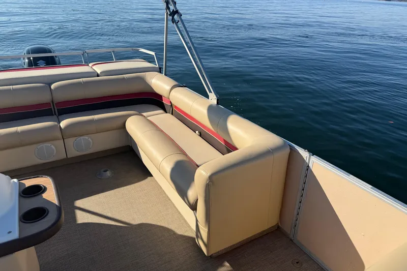 Slide: The Image of 1997 Crest CREST II DLX pontoon boat interior with beige seating and lake view. - 26