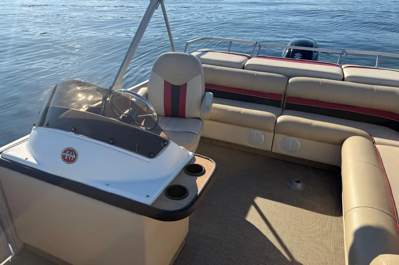 Slide: The Image of 1997 Crest CREST II DLX pontoon boat interior with beige seating and steering console. - 27