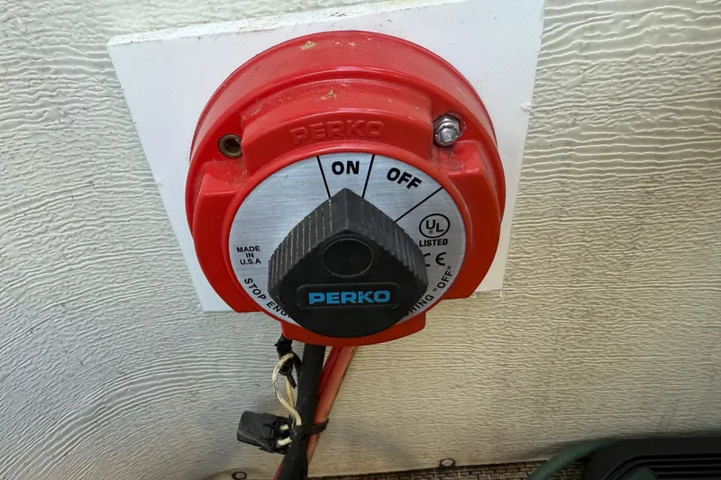 Slide: The Image of Red Perko battery switch on a 1997 Crest II DLX boat, showing "ON" and "OFF" positions. - 31