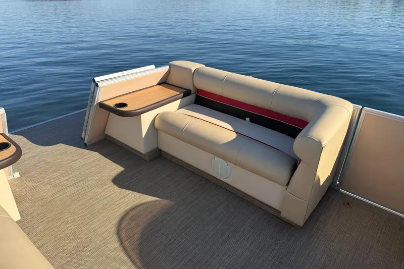 Slide: The Image of 1997 Crest CREST II DLX pontoon boat interior with beige seating and wooden accents on a lake. - 32