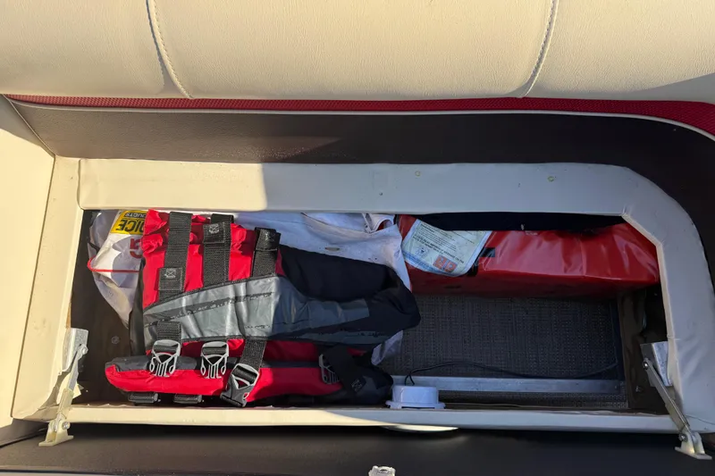Slide: The Image of Storage compartment in a 1997 Crest CREST II DLX boat with life jackets and supplies. - 36