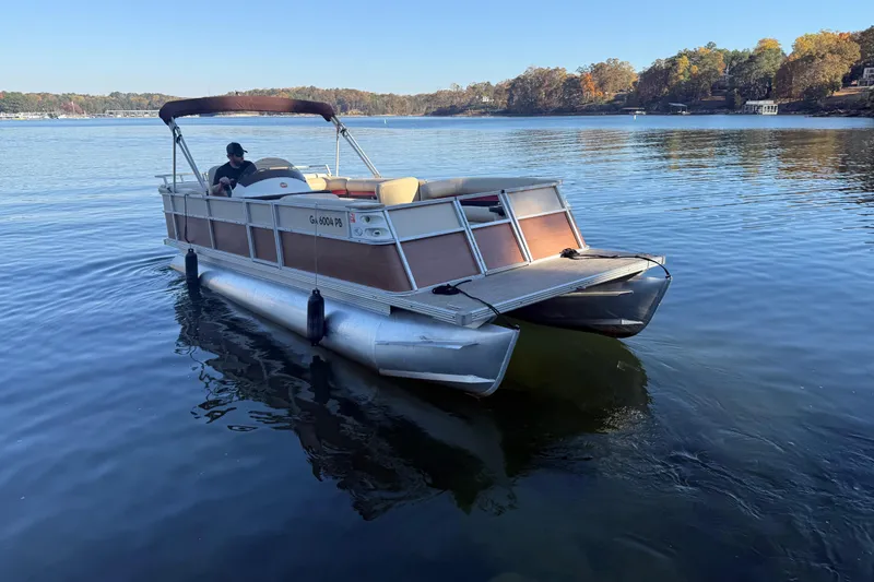 Slide: The Image of 1997 Crest CREST II DLX pontoon boat on a calm lake with autumn trees. - 5