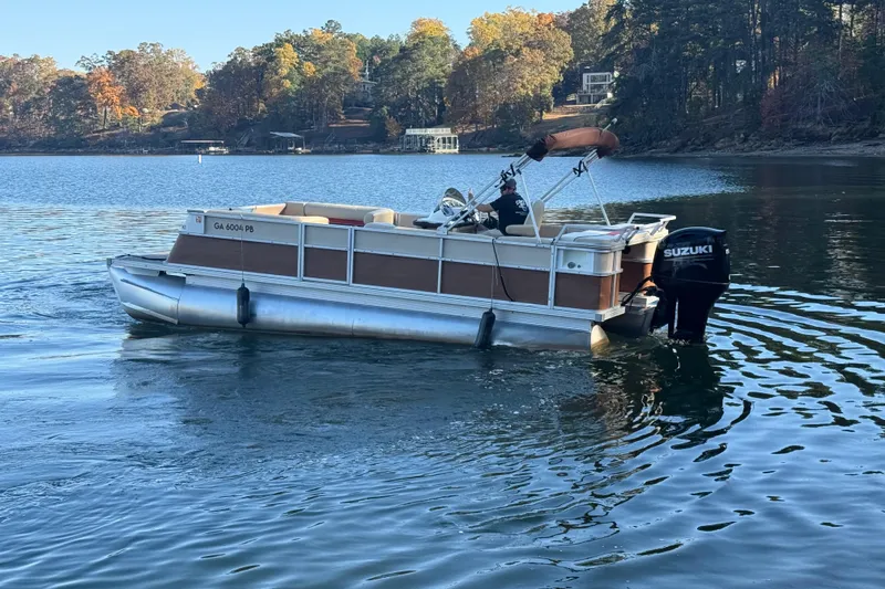 Slide: The Image of 1997 Crest CREST II DLX pontoon boat on a serene lake with autumn trees. - 6