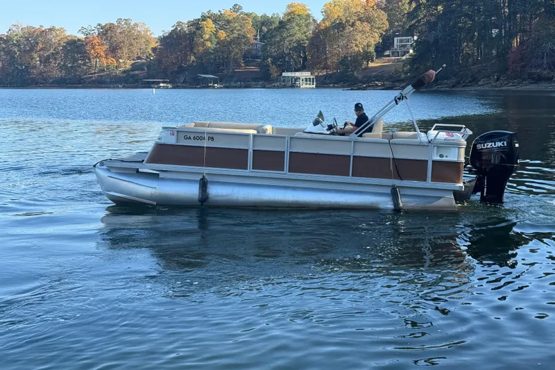 Slide: The Image of 1997 Crest CREST II DLX pontoon boat on a scenic lake with autumn foliage. - 9
