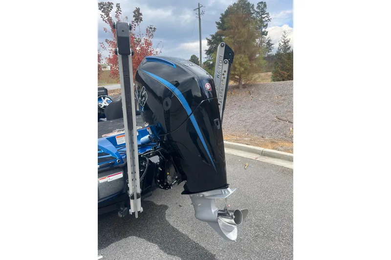 Slide: The Image of 2024 Nitro Z20 boat engine with sleek black and blue design, parked outdoors. - 13