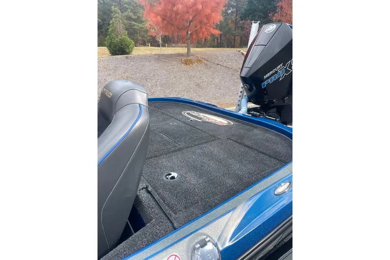 Slide: The Image of 2024 Nitro Z20 boat with Mercury Pro XS engine, parked near autumn trees. - 2