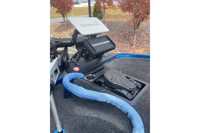 Slide: The Image of 2024 Nitro Z20 boat dashboard with Garmin and Humminbird electronics, surrounded by autumn foliage. - 5