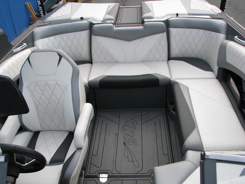 Slide: The Image of 2017 Tigé Z1 boat interior with gray and white seating, featuring diamond stitching and branded flooring. - 6