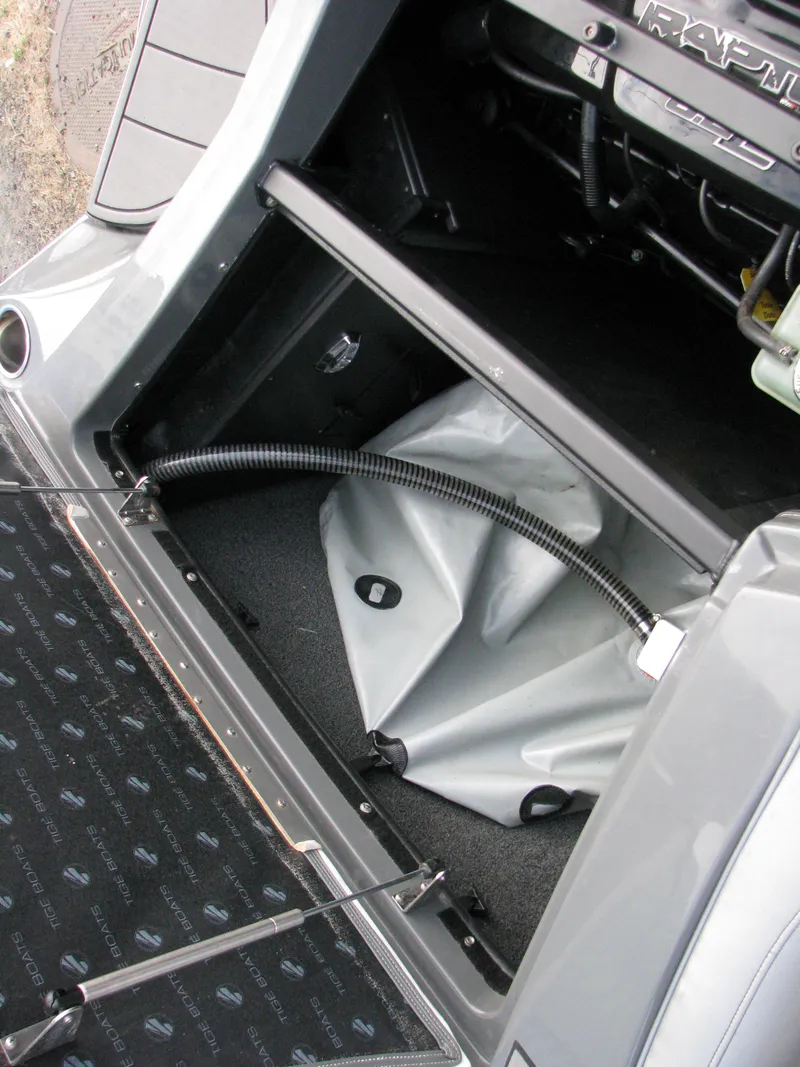 Slide: The Image of 2017 Tigé Z1 boat storage compartment with ballast bag and hoses. - 7