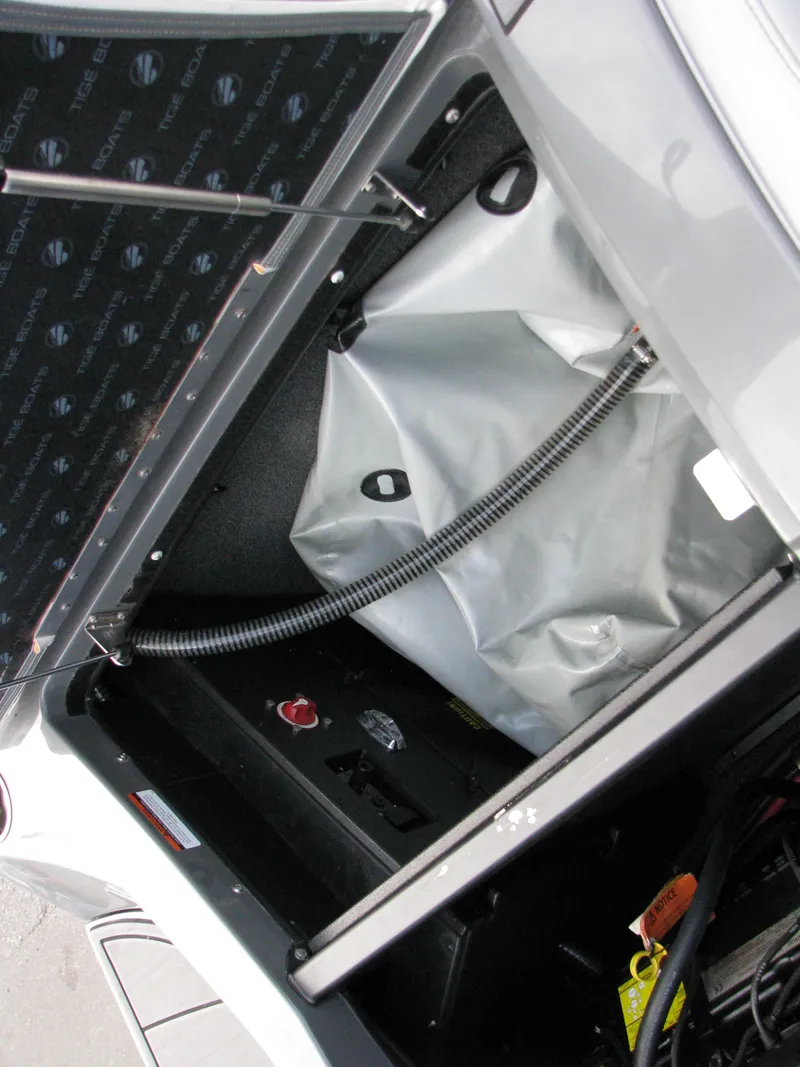 Slide: The Image of 2017 Tigé Z1 boat storage compartment with silver lining and wiring. - 8