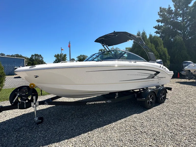 Slide: The Image of 2024 Chaparral 21 SSi OB boat on a trailer, displayed outdoors. - 1