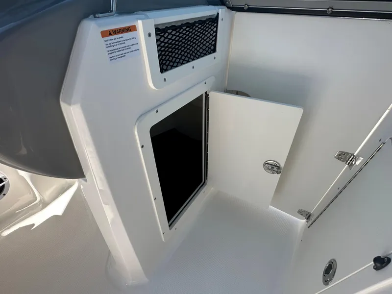Slide: The Image of Open storage compartment on 2024 Chaparral 21 SSi OB boat. - 16