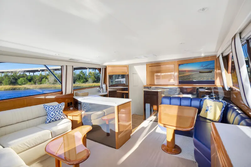 Slide: The Image of Luxurious interior of 2001 Viking 50 Convertible yacht with elegant seating and scenic views. - 14