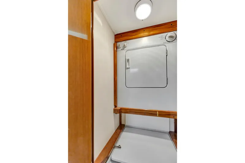 Slide: The Image of Laundry area inside 2001 Viking 50 Convertible yacht with wooden accents. - 19