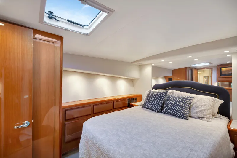 Slide: The Image of Luxurious bedroom interior of 2001 Viking 50 Convertible yacht with elegant wood finishes. - 22