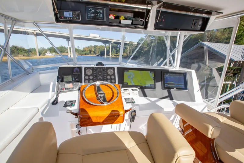 Slide: The Image of Helm of 2001 Viking 50 Convertible yacht with navigation screens and controls. - 8