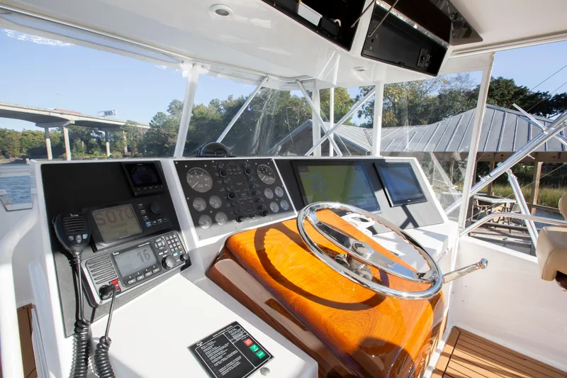 Slide: The Image of Helm of 2001 Viking 50 Convertible yacht with modern navigation equipment and wooden steering wheel. - 9