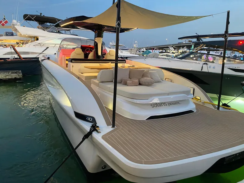 Slide: The Image of 2024 Solaris Power 40 Open luxury yacht docked at marina during evening. - 10
