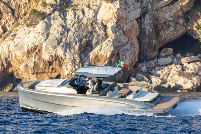 Slide: The Image of 2024 Solaris Power 40 Open luxury yacht cruising near rocky coastline. - 19