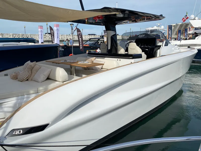 Slide: The Image of 2024 Solaris Power 40 Open luxury yacht docked at marina. - 2