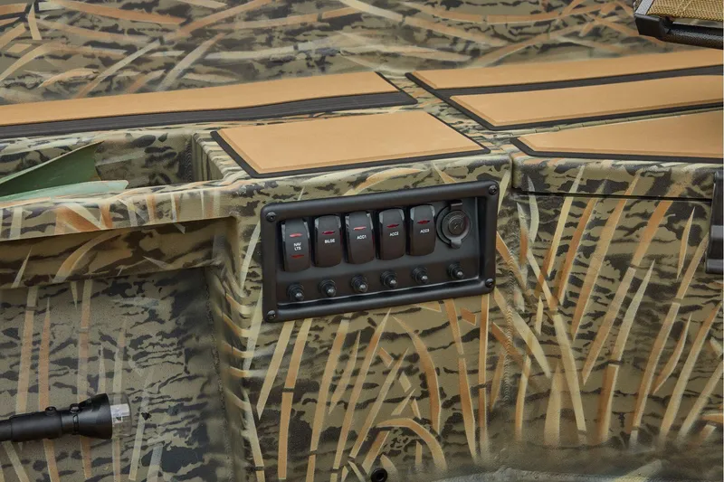 Slide: The Image of 2026 Tracker Grizzly 1756 T Marsh boat interior with camo design and control panel. - 34