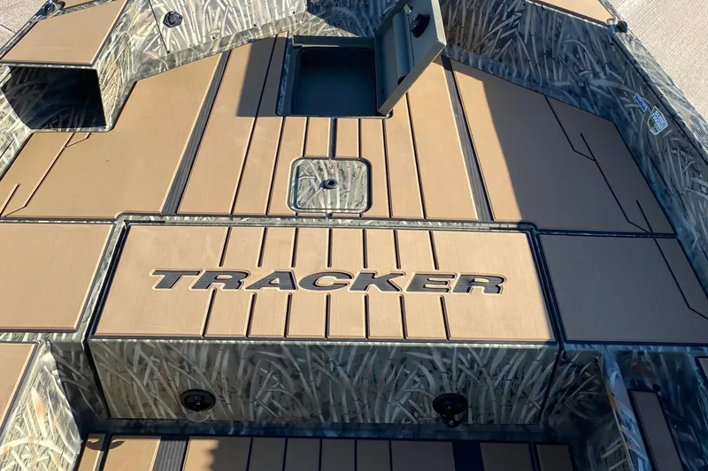 Slide: The Image of 2026 Tracker Grizzly 1756 T Marsh boat interior with camo design and storage compartments. - 6