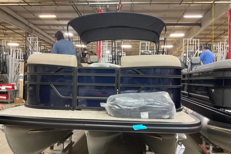 Slide: The Image of 2026 Bennington 22 SSRSE pontoon boat in a warehouse setting. - 5
