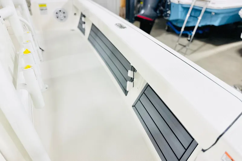 Slide: The Image of 2026 Pathfinder 2200 TRS boat interior with rod holders and storage compartments. - 10