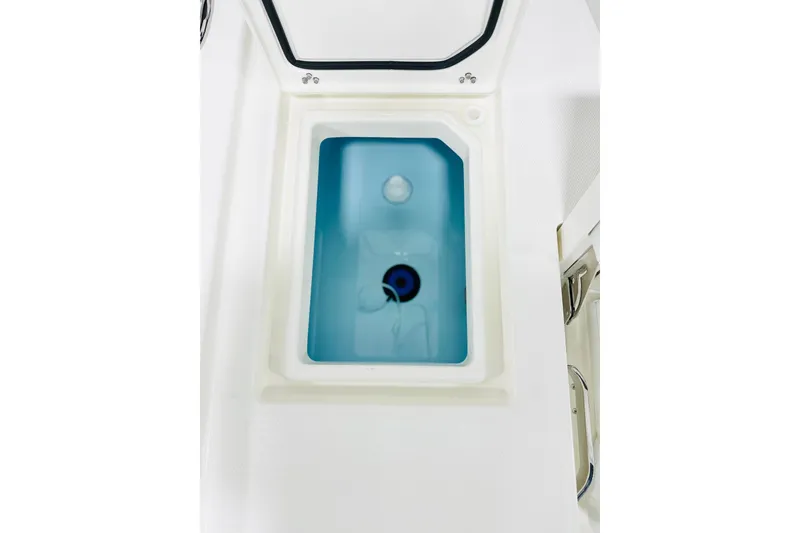 Slide: The Image of Livewell compartment of 2026 Pathfinder 2200 TRS boat, featuring a blue interior. - 13