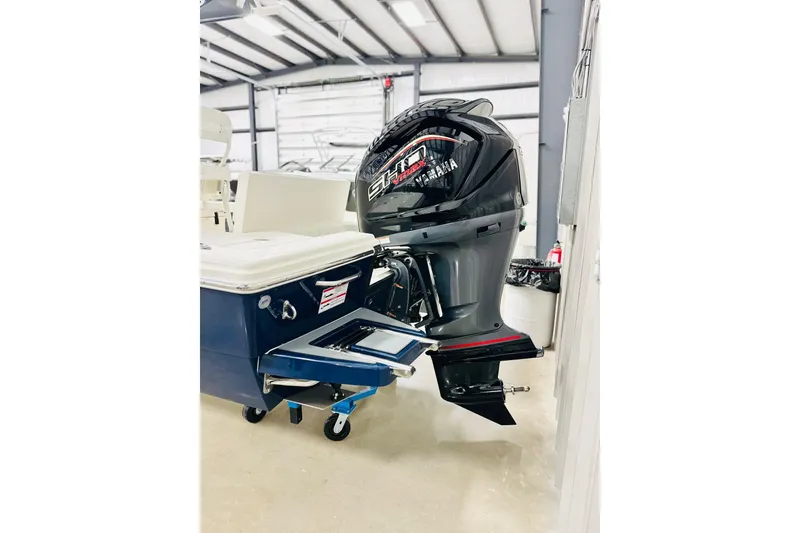 Slide: The Image of 2026 Pathfinder 2200 TRS boat with Yamaha outboard motor in a showroom. - 14