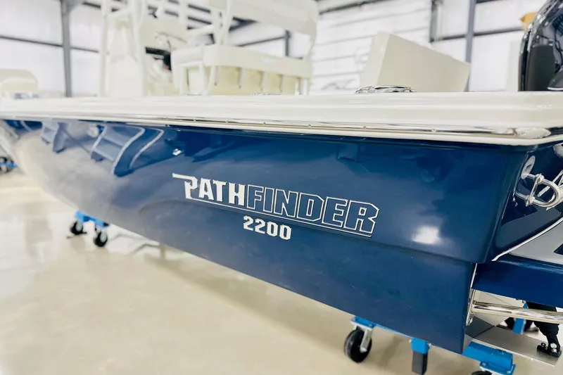 Slide: The Image of 2026 Pathfinder 2200 TRS boat in showroom, blue hull with logo visible. - 15