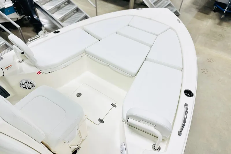 Slide: The Image of 2026 Pathfinder 2200 TRS boat interior with white cushioned seating and storage compartments. - 7