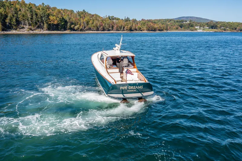 Slide: The Image of Hinckley Talaria 44 Express yacht cruising on a scenic lake, 2002 model. - 12