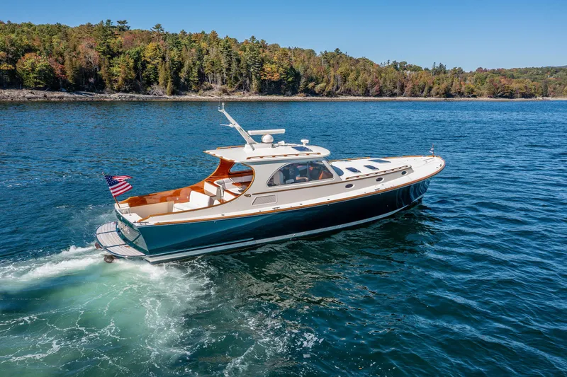 Slide: The Image of 2002 Hinckley Talaria 44 Express cruising on a scenic lake with forested shoreline. - 15