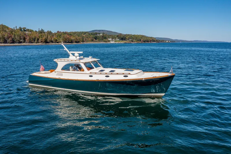 Slide: The Image of 2002 Hinckley Talaria 44 Express yacht cruising on serene blue waters. - 17