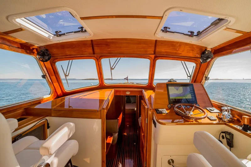 Slide: The Image of Interior of 2002 Hinckley Talaria 44 Express yacht with wooden dashboard and ocean view. - 25