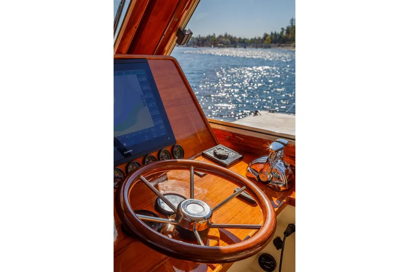 Slide: The Image of Helm of 2002 Hinckley Talaria 44 Express with wooden steering wheel and navigation screen. - 28