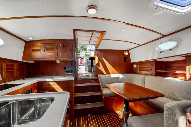 Slide: The Image of Luxurious 2002 Hinckley Talaria 44 Express yacht interior with elegant wood finish and cozy seating. - 31