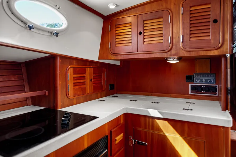 Slide: The Image of Hinckley Talaria 44 Express 2002 yacht interior with wooden cabinetry and modern kitchen amenities. - 35