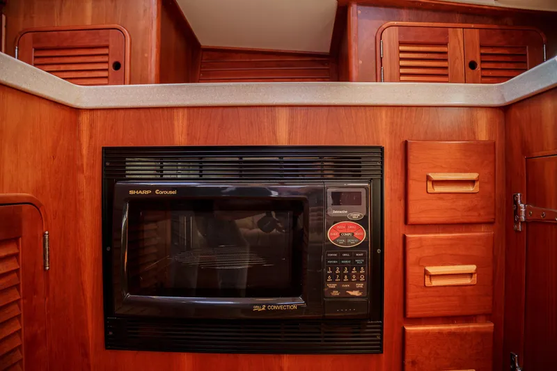 Slide: The Image of Hinckley Talaria 44 Express 2002 yacht kitchen with Sharp Carousel microwave. - 36