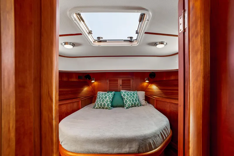 Slide: The Image of Luxurious cabin interior of 2002 Hinckley Talaria 44 Express yacht with skylight and cozy bedding. - 39