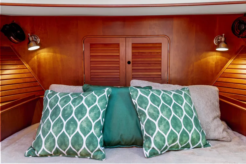 Slide: The Image of Cozy cabin interior of 2002 Hinckley Talaria 44 Express with green decorative pillows. - 42
