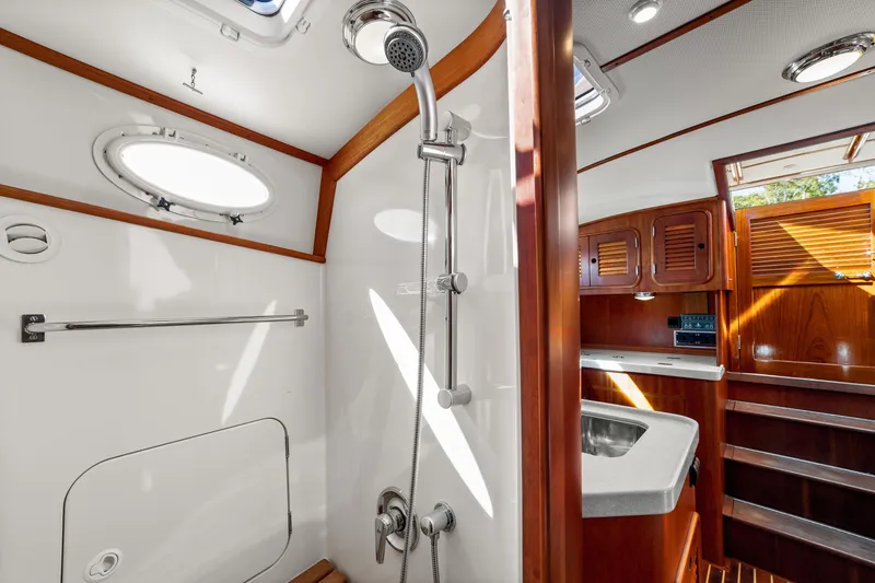 Slide: The Image of Luxurious 2002 Hinckley Talaria 44 Express yacht bathroom with wood accents and modern fixtures. - 48
